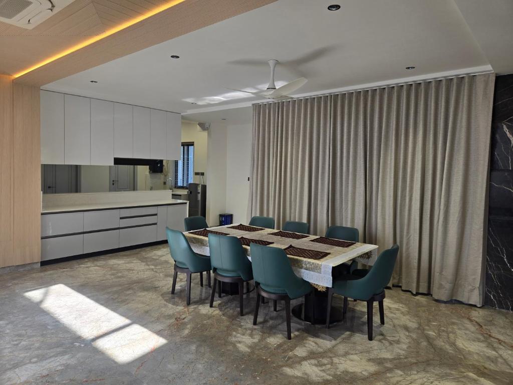 a dining room with a table and blue chairs at Satish Villa in Hyderabad