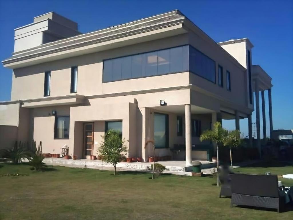 a large white house with a lot of windows at Dreamanor Blissful Stay Amritsar in Amritsar
