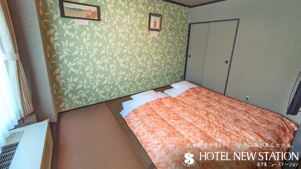 Postel nebo postele na pokoji v ubytování Hotel New Station