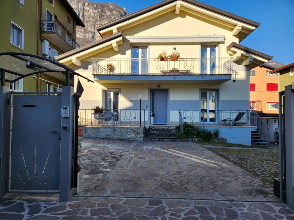 a house with a gate in front of it at Casa Vincy, Costa Volpino Ospitar in Costa Volpino