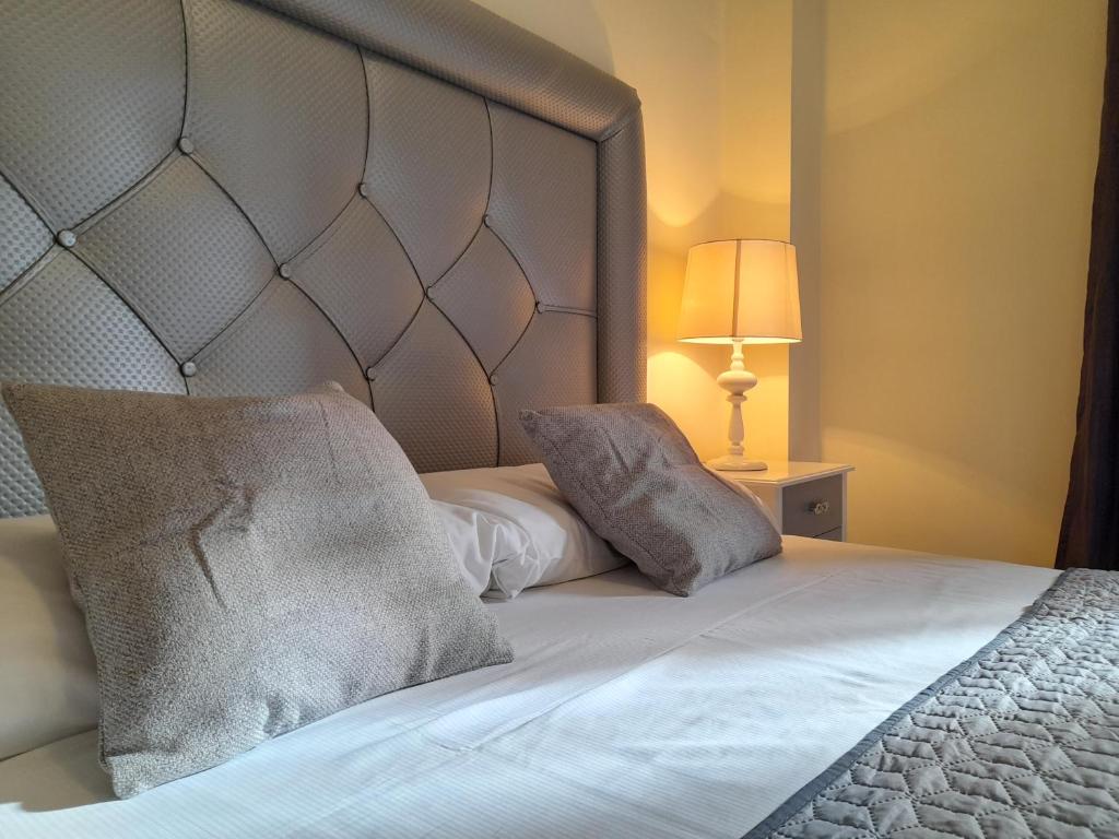 a bed with two pillows on top of it at Apartamento de dos dormitorios y un baño con piscinas y jardines cercano a la playa in Estepona