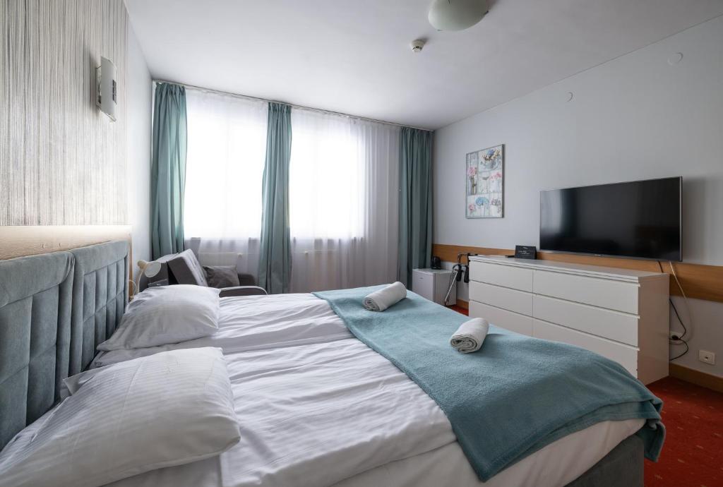 Postel nebo postele na pokoji v ubytování Hotel Orbita