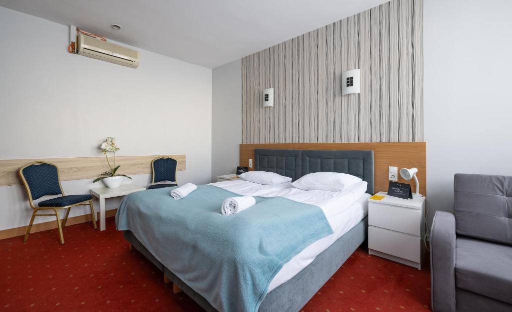 Postel nebo postele na pokoji v ubytování Hotel Orbita