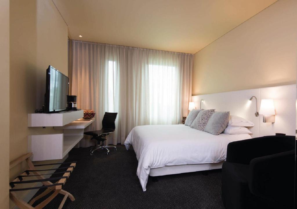 Postel nebo postele na pokoji v ubytování Movich Hotel Las Lomas
