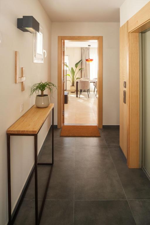 a living room with a table and a hallway at Panasco Suites in Arrecife