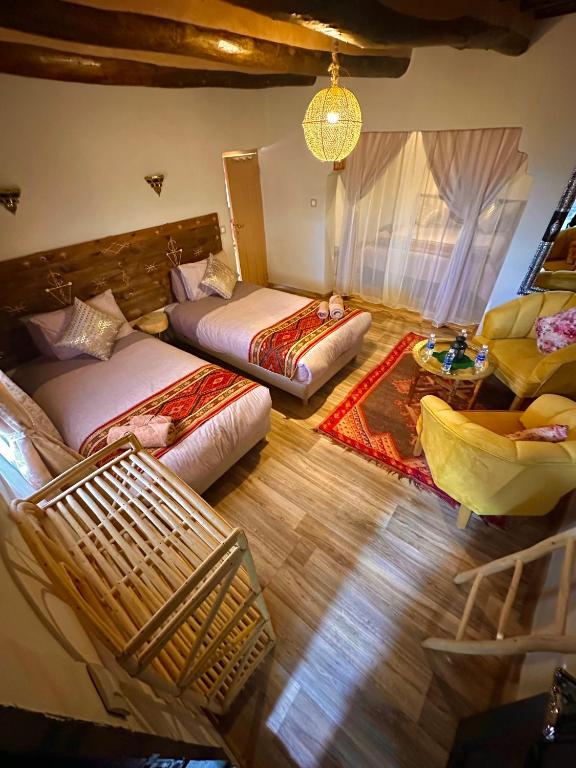 an aerial view of a living room with two beds and a couch at Kasbah El Hajja in Aït Benhaddou