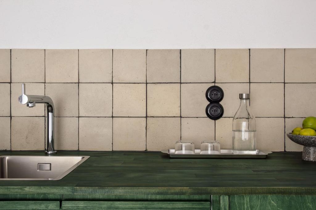 a kitchen with a counter with a sink and a counter top at Wolne Pokoje I Boutique Apartments in Wrocław