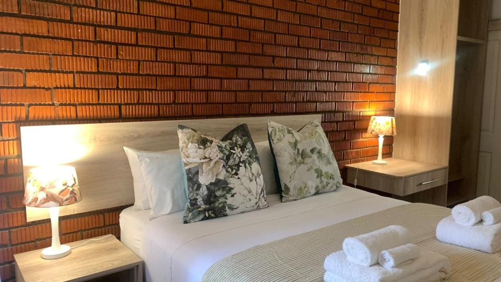 a bedroom with a bed with two towels on it at Pinetown Accommodation in Pinetown