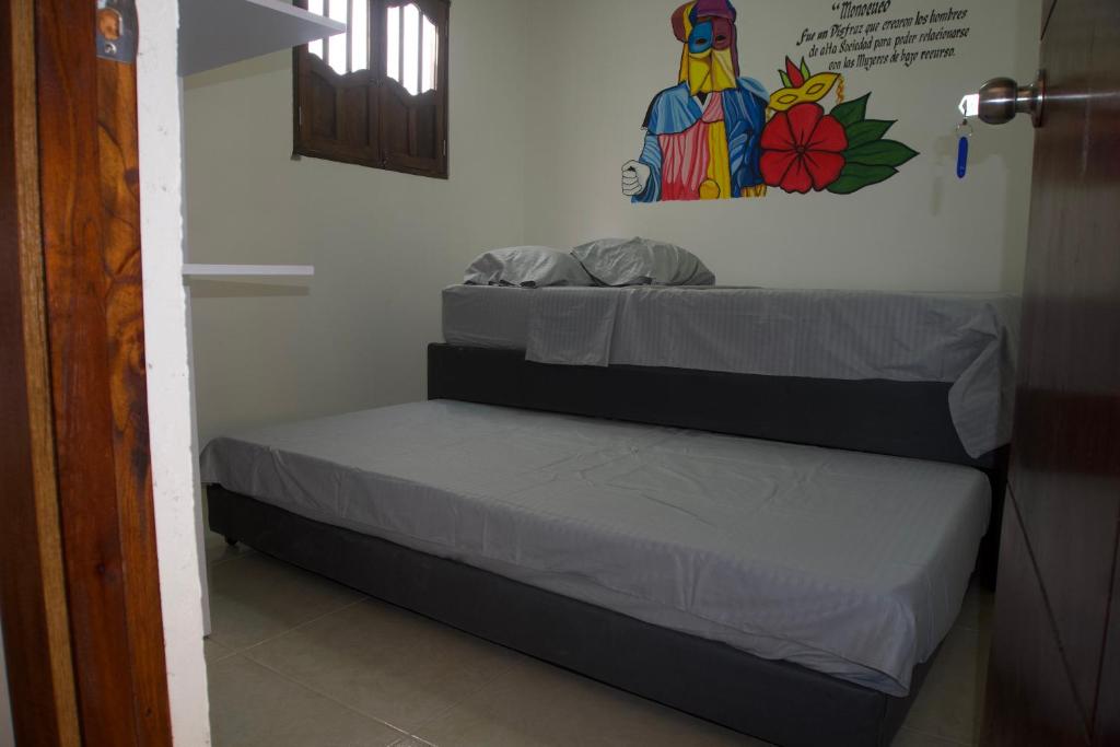 Postel nebo postele na pokoji v ubytování Hostal Barrio Abajo