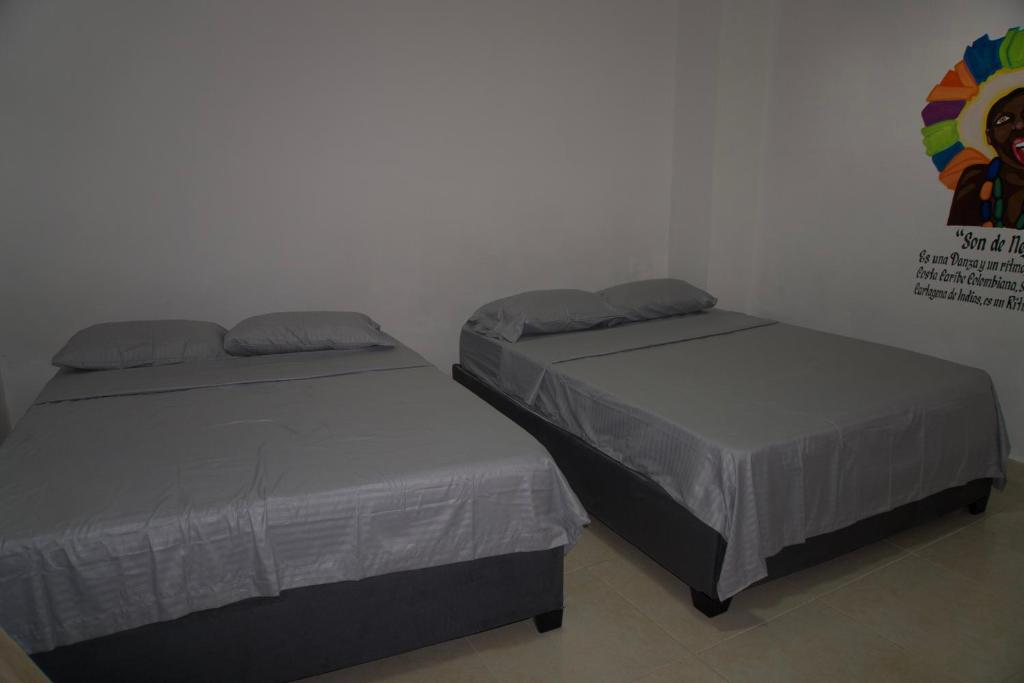 Postel nebo postele na pokoji v ubytování Hostal Barrio Abajo