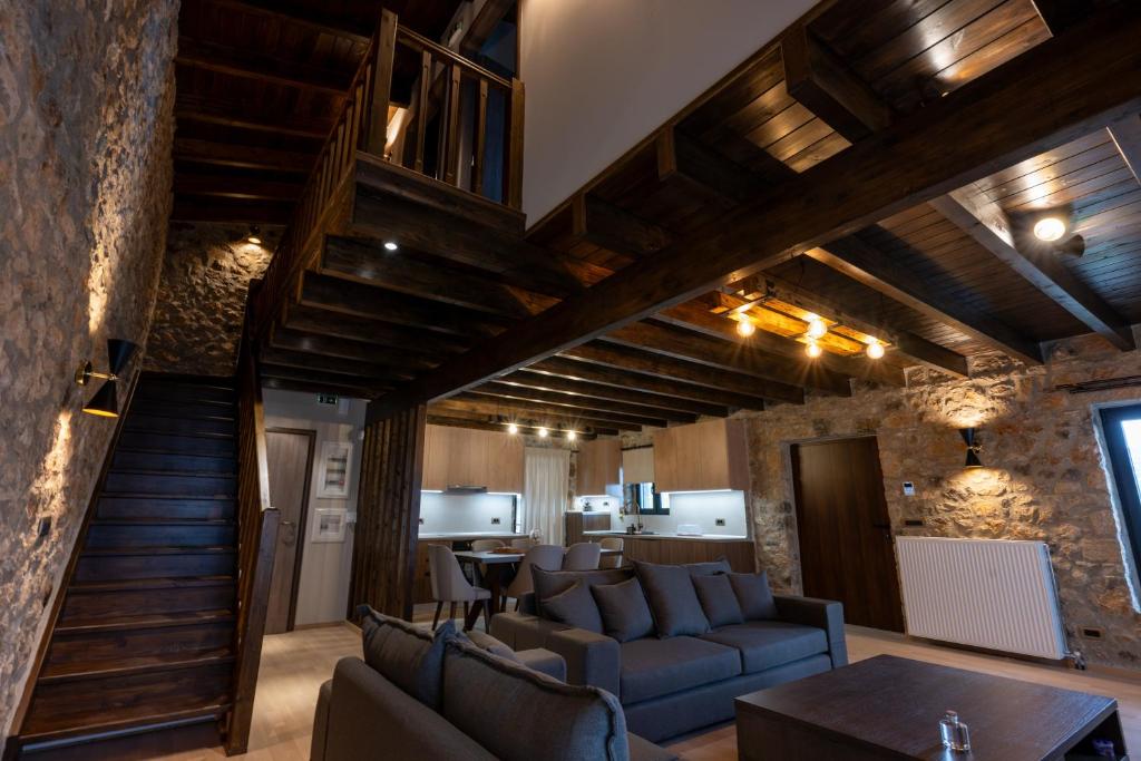 a living room with a couch and a table at Eptalofos Mountain Resorts in Eptalofos