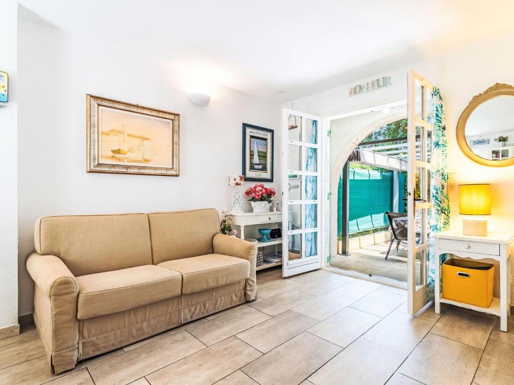 a living room with a couch and a table at Holiday Home Les Parcs de Gassin-1 by Interhome in Saint-Tropez