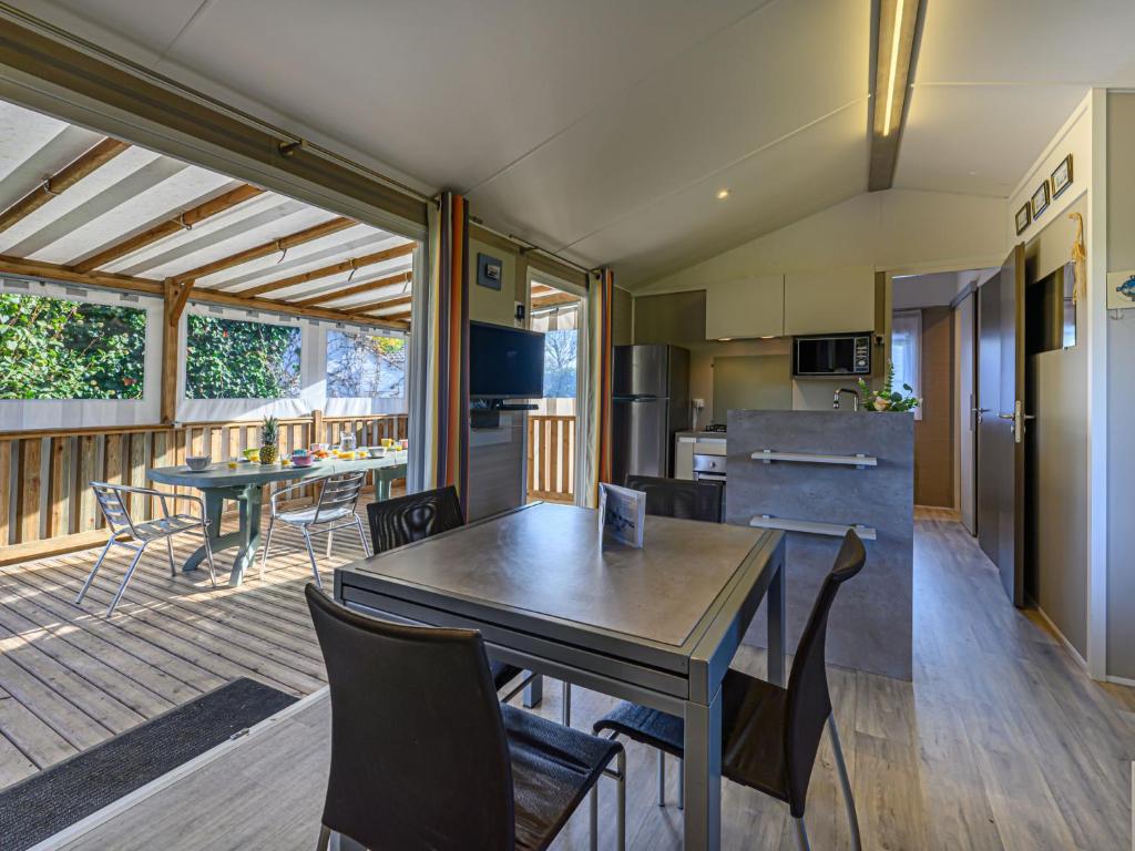 kuchnia i jadalnia ze stołem i krzesłami w obiekcie Apartment Le Colvert by Interhome w mieście Carnac