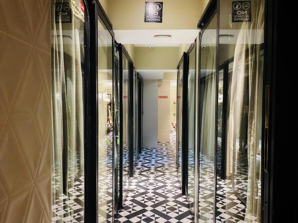 a hallway of a store with black and white tiled floors at Sulu Stay Inn Near Mumbai International Airport in Mumbai
