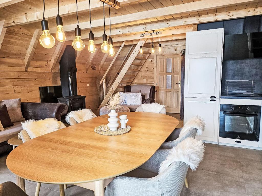 a dining room with a wooden table and chairs at Chalet Tomina Koliba Lika by Interhome in Lovinac