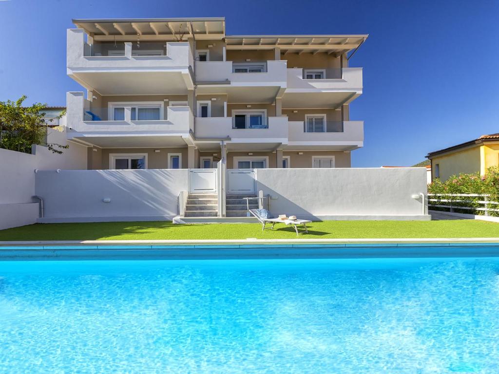 a building with a swimming pool in front of a building at Apartment La terrazza sulla piscina by Interhome in Valledoria