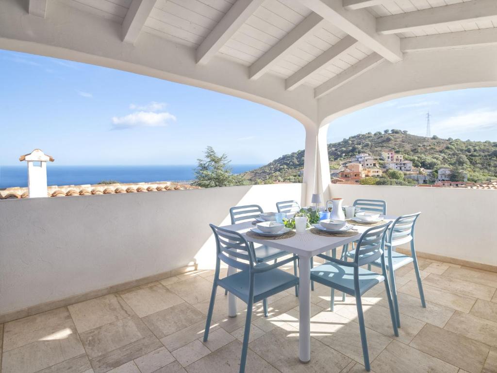 a table and chairs on a balcony with a view of the ocean at Holiday Home La Conchiglia D'oro by Interhome in Budoni