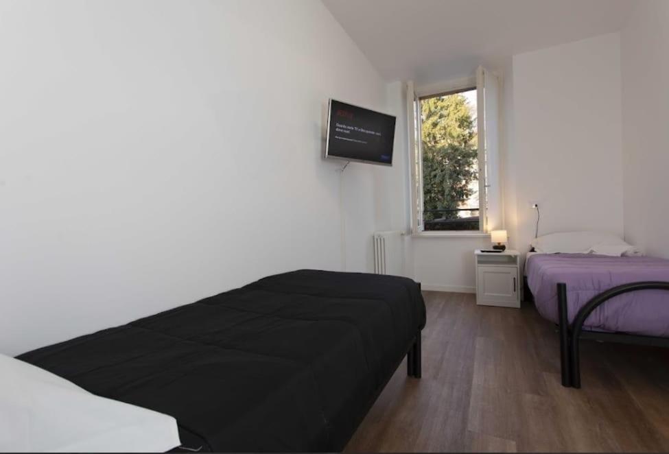 Postel nebo postele na pokoji v ubytování Max Rooms Bergamo