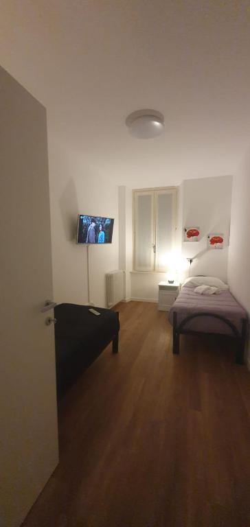 Postel nebo postele na pokoji v ubytování Max Rooms Bergamo