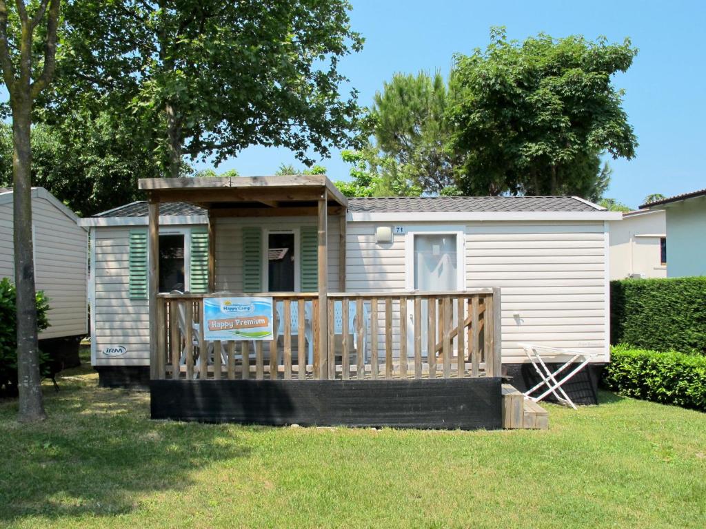a house with a porch with a sign in the yard at Holiday Home Happy Premium by Interhome in Rosapineta