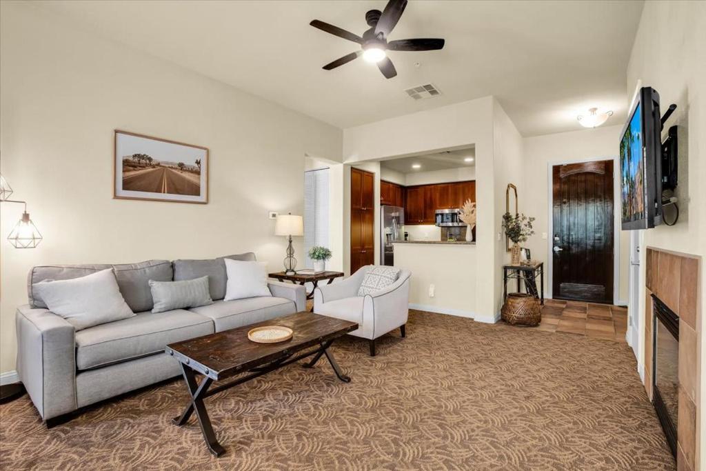 a living room with a couch and a table at Relax & Recharge at this 2BR Desert Villa in La Quinta