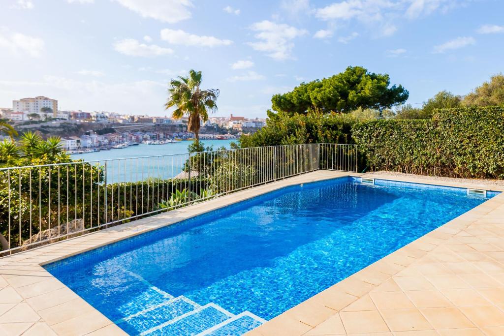 a swimming pool with a view of the water at FLOR Villa Marina - Puerto Mahón in Mahón