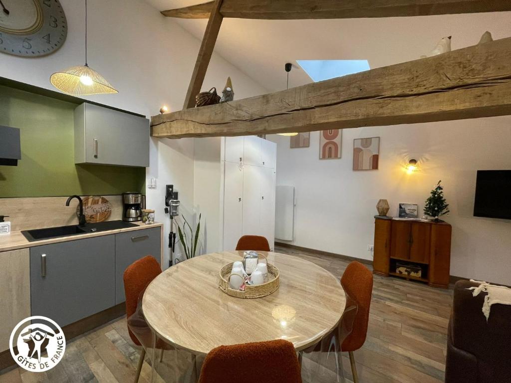 a kitchen and dining room with a table in a room at Charmant gîte en Vendée proche Puy du Fou - FR-1-426-566 in Saint-Hilaire-le-Vouhis