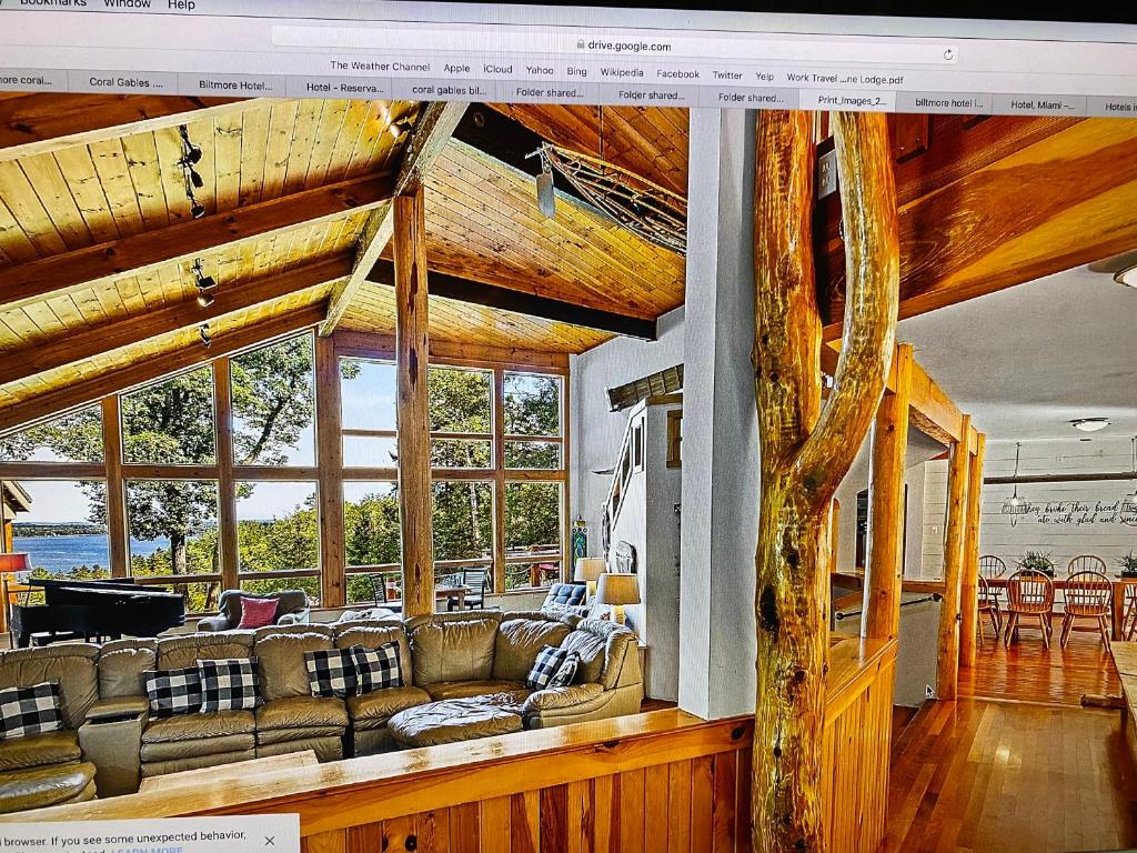 a living room with a couch and some windows at The Pine Lodge in Northport