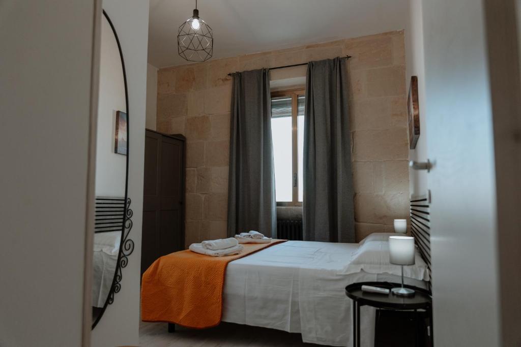 a bedroom with a bed and a large mirror at [Otranto in 10 min]-Free Parking in Maglie