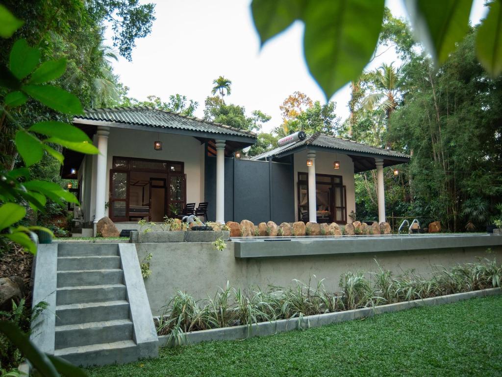 a house with a garden in front of it at The Lush - Luxury Villa in Unawatuna