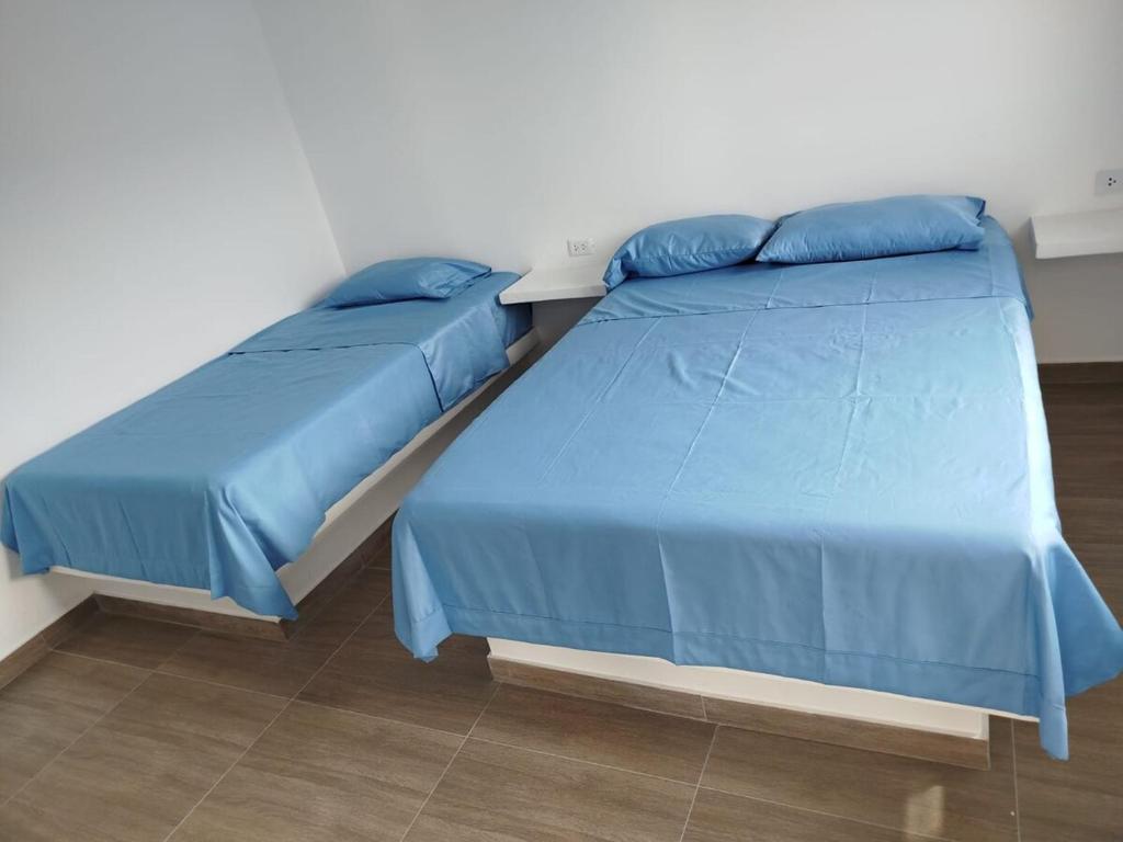 two beds sitting next to each other in a bedroom at CASA DE PLAYA FRENTE AL MAR k173 in San Vicente de Cañete