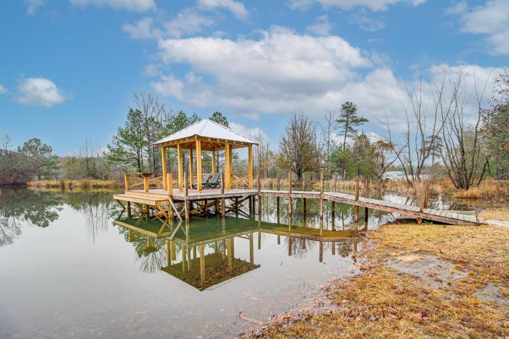 a gazebo sitting in the middle of a lake at Kayak and Fish Little River Canyon Lakefront Cabin in Fort Payne