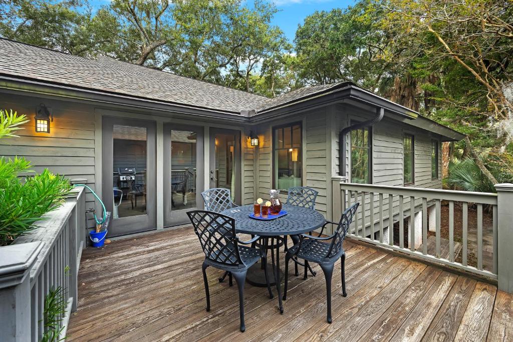 a patio with a table and chairs on a deck at FR480: 480 Fiddlers Reach in Kiawah Island