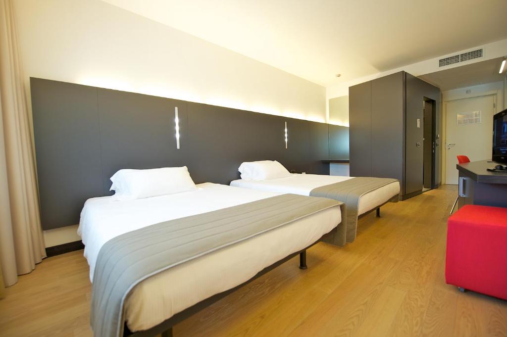 Posteľ alebo postele v izbe v ubytovaní Mercure Nerocubo Rovereto