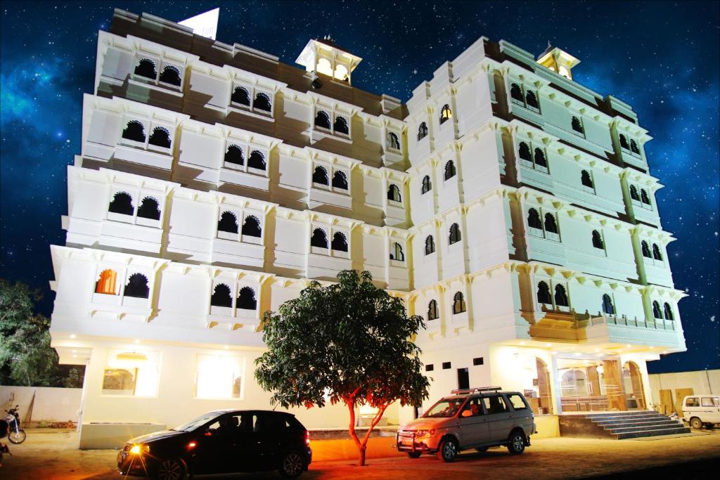 a building with cars parked in front of it at Hotel Riddhi Inn in Udaipur