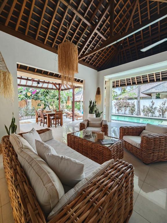 a living room with a couch and chairs and a table at Villa Dunia - 400M Private Villa Walk to Beach Top location Gili Trawangan in Gili Trawangan