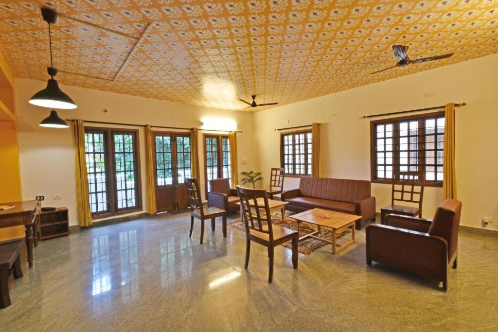 a living room with a couch and a table at Villa close to Rock beach-Family Room in Puducherry