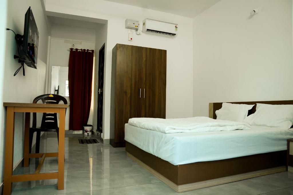 Voodi või voodid majutusasutuse Jayalakshmi Residency toas