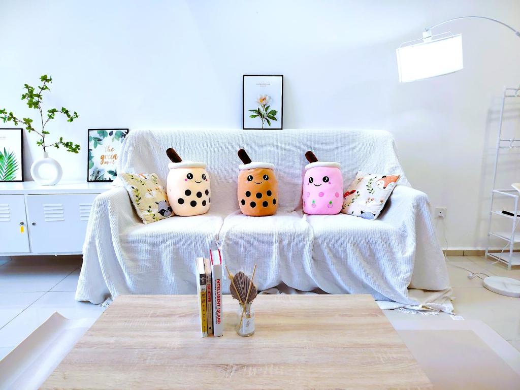 a group of pillows on a couch in a living room at Ekocheras Cozy Loft in Kuala Lumpur