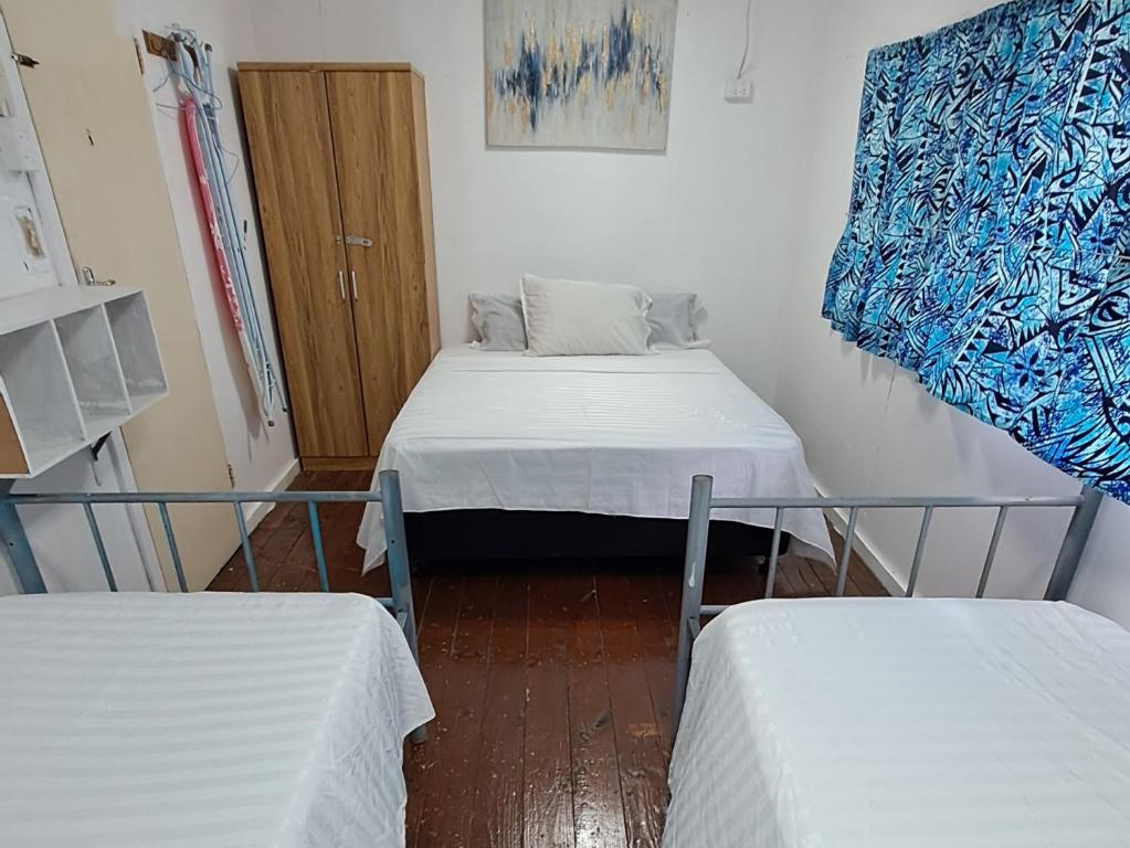 Postel nebo postele na pokoji v ubytování Samoa Home
