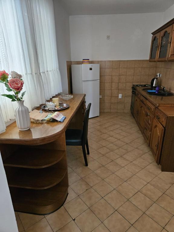 a kitchen with a table with a vase of flowers on it at Elsas Residence in Sarajevo