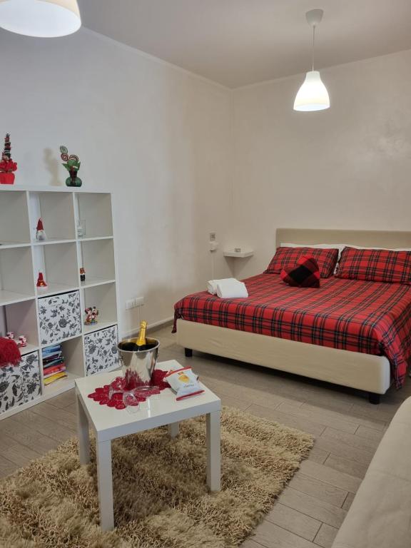 a bedroom with a bed and a table with a coffee table at A casa di Pablo in Collodi