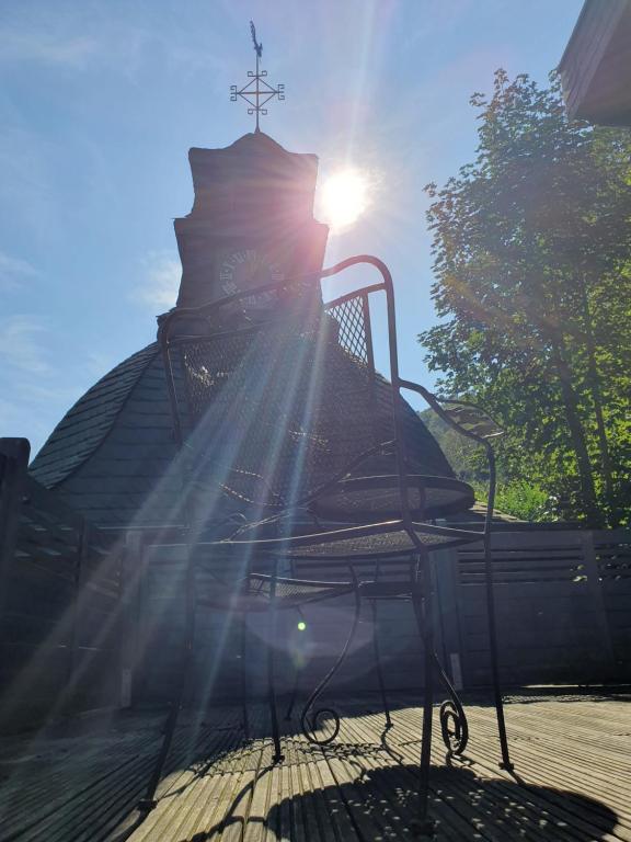 a bench with the sun shining behind it at Burgberg in Altena