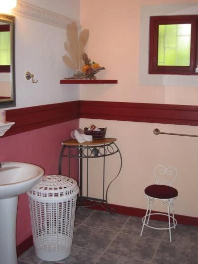 a bathroom with a sink and a toilet and a stool at The Legend Garden Condos in Saint Peter