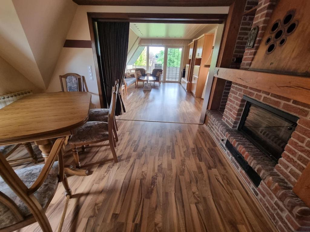 a living room with a table and a fireplace at Ferienwohnung Looser Patt in Tecklenburg in Tecklenburg