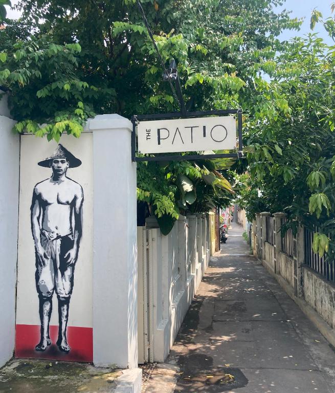 a street sign with a man painted on the side of a building at The Patio Yogya in Yogyakarta