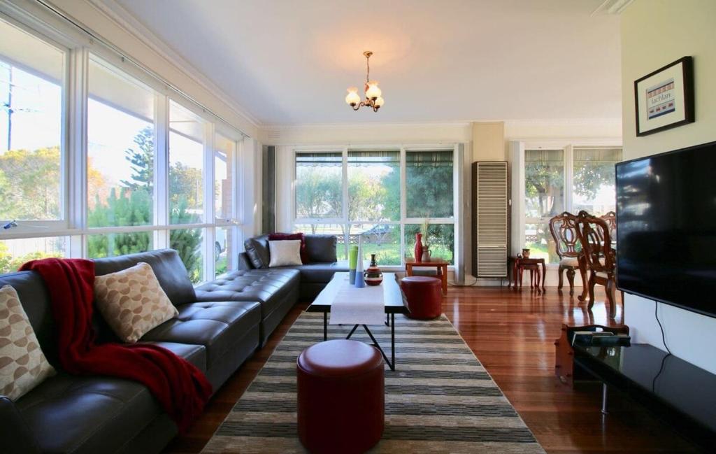 a living room with a couch and a tv at Rosebud Comfort Retreat in Rosebud