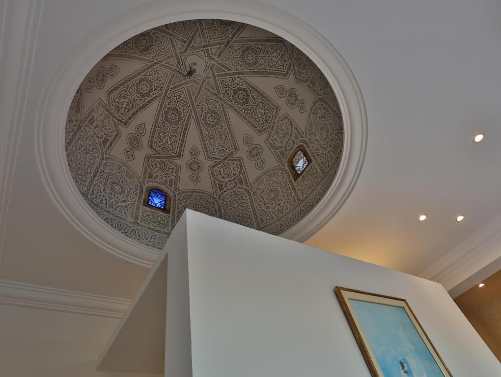 a ceiling with a painting on it in a room at Dar Souad in La Marsa