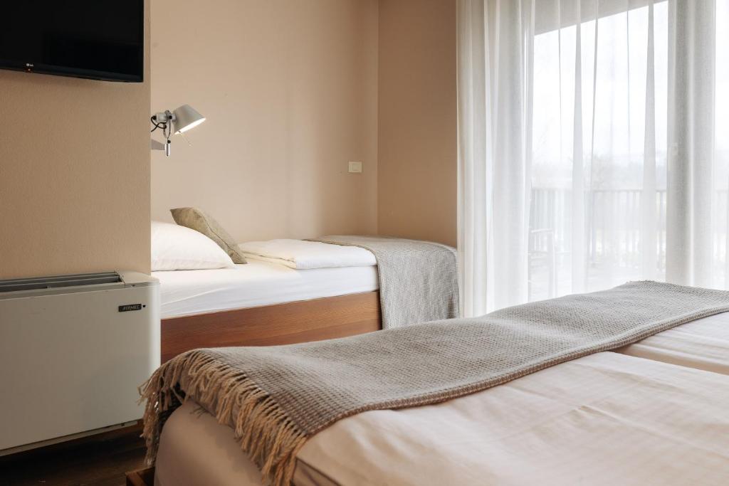 Postel nebo postele na pokoji v ubytování Hotel Rakar