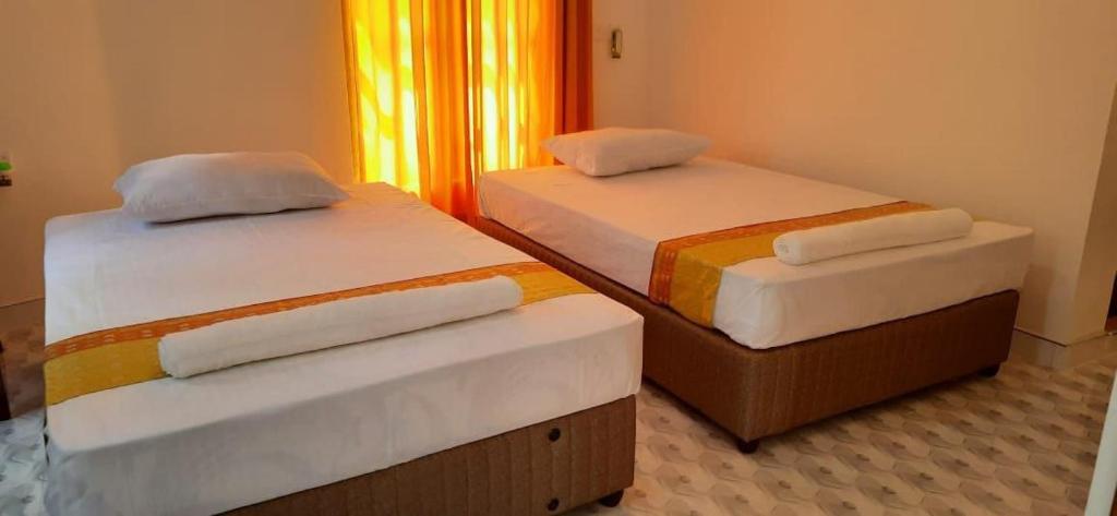 Postel nebo postele na pokoji v ubytování Thambara Resort